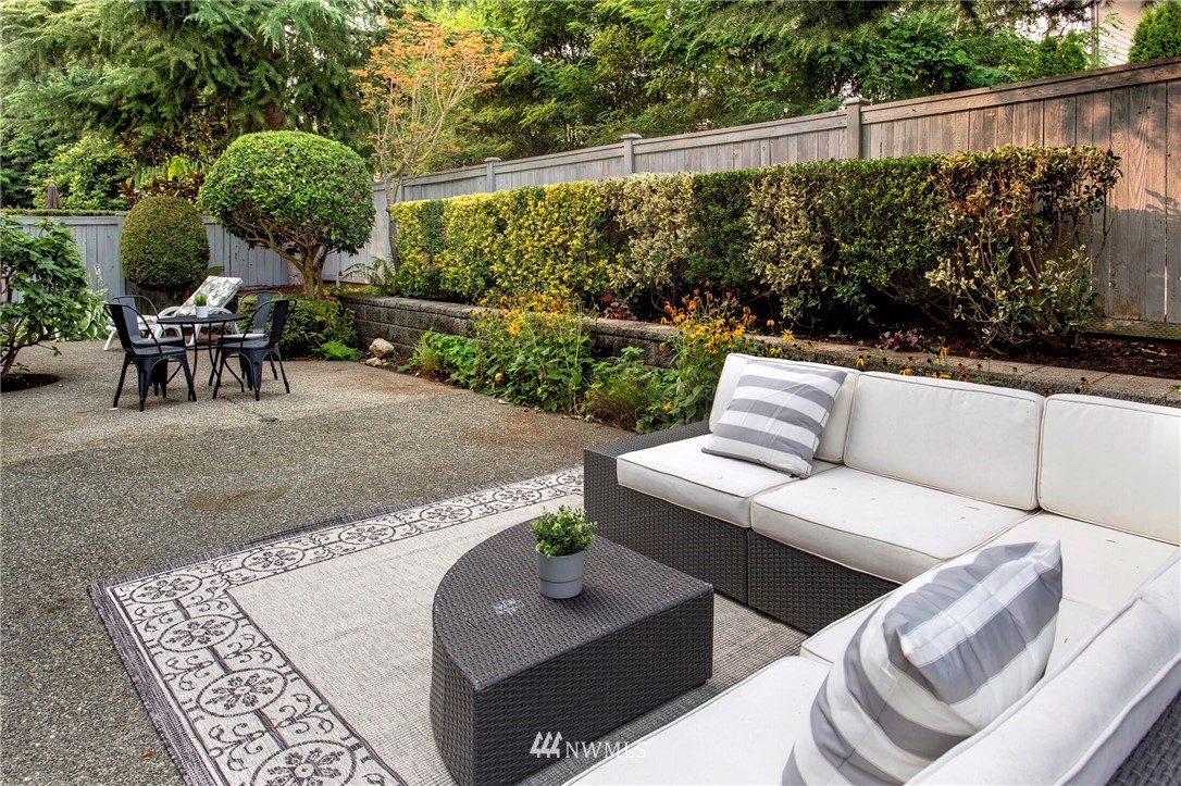 1038 North 27th Place Renton, WA 98056 - Photo 22 of 27 a view of a patio with couches table and chairs with plants and garden