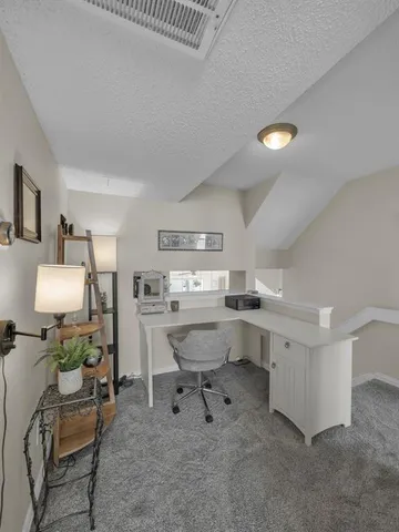 a view of a workspace with furniture