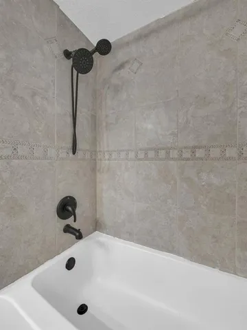 a bathroom with a granite countertop sink a toilet and a large mirror