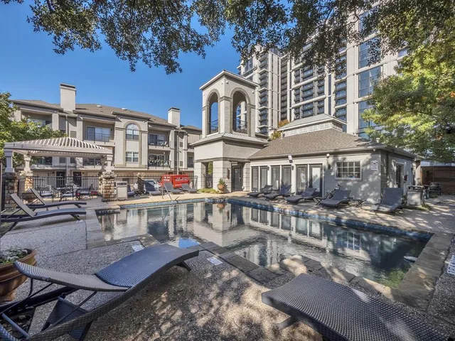 a view of a building with swimming pool and sitting area