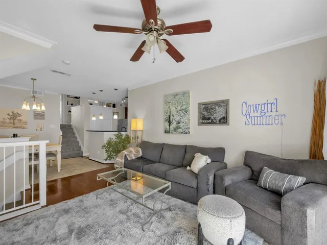 a living room with furniture and a chandelier