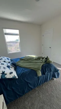 a bedroom with bed and window