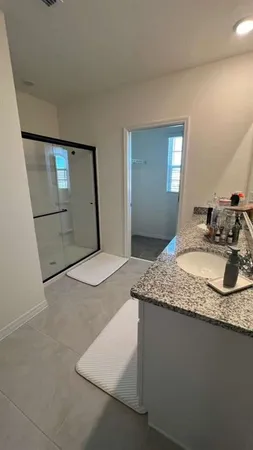a bathroom with a granite countertop toilet sink and mirror