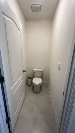 a white toilet sitting next to a white sink