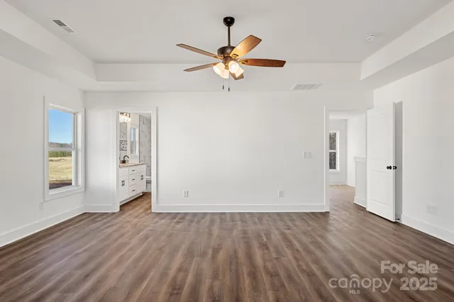 a bathroom with a granite countertop sink a toilet and a shower