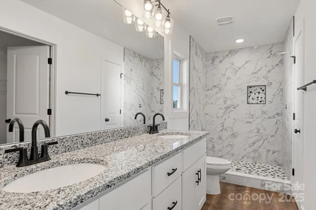 a bathroom with a toilet and a shower curtain