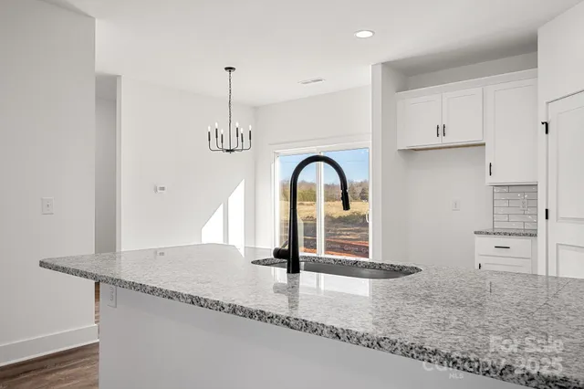 a view of a kitchen counter top space and staircase