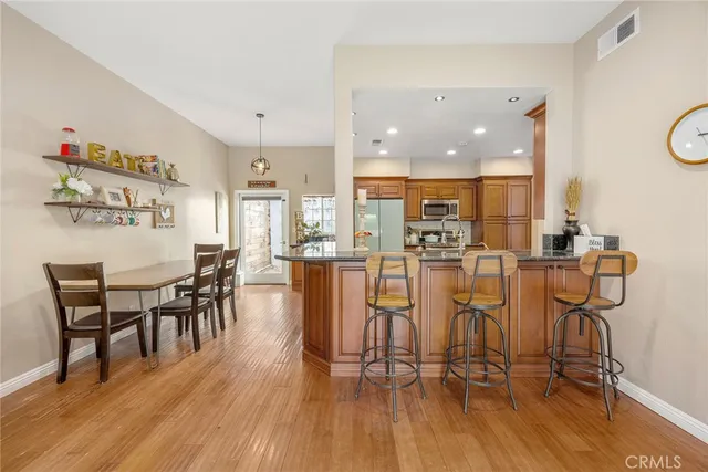 a dining room with furniture and wooden floor