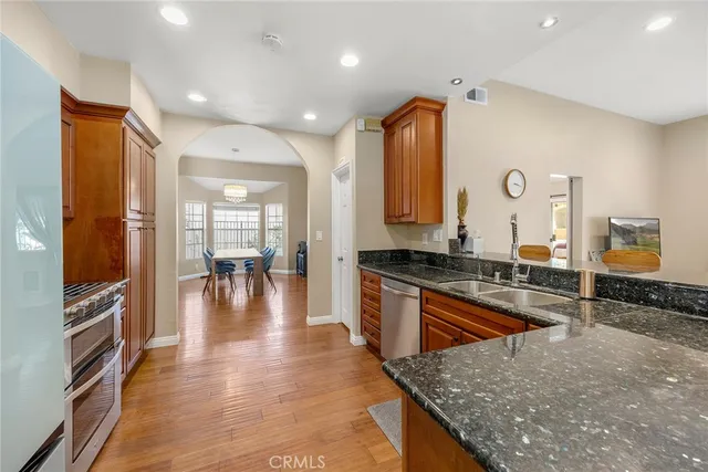 a kitchen with stainless steel appliances granite countertop a stove and a sink