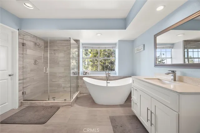 a spacious bathroom with a double vanity sink mirror and