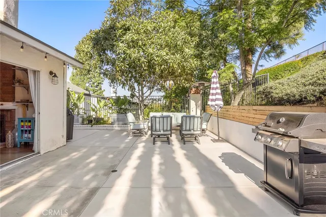 a view of backyard with a table and chairs and potted plants