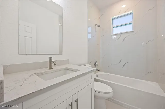 a bathroom with a sink a toilet and a bathtub