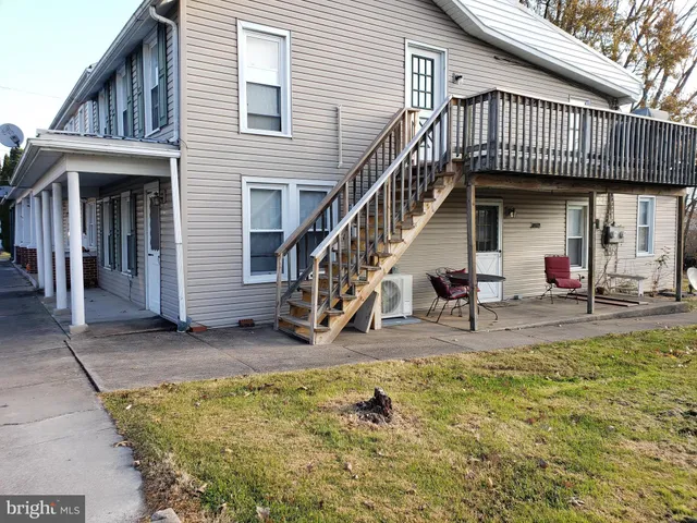 a view of a house with swimming pool and porch