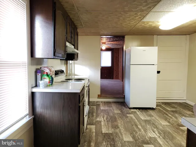a kitchen with a refrigerator and a sink