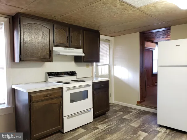 a kitchen with a stove and a refrigerator