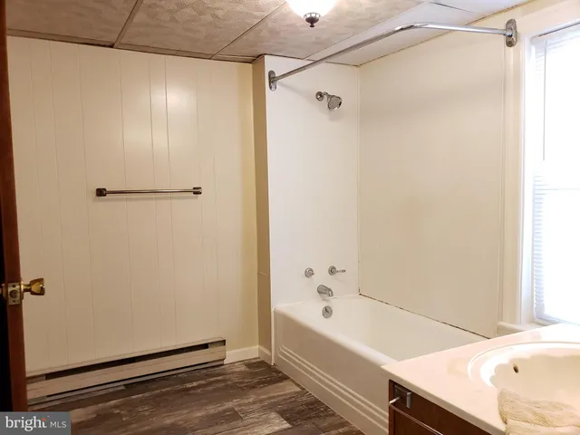 a bathroom with a bathtub and a shower