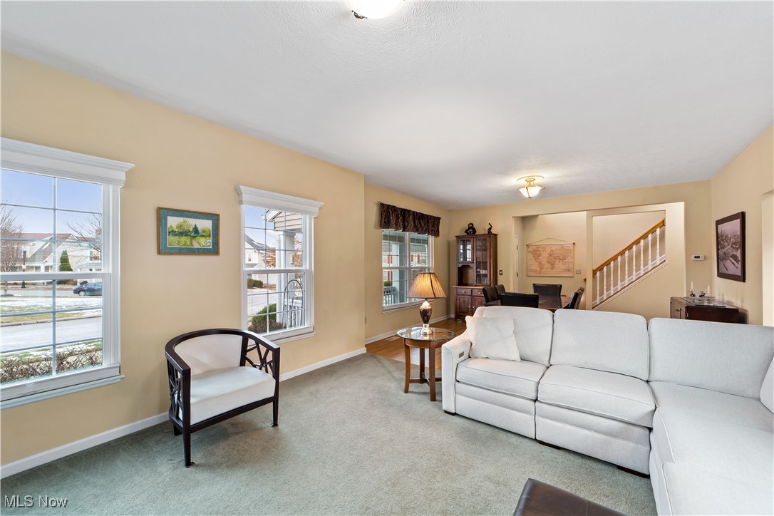 4461 Sexton Road Cleveland, OH 44105 - Photo 3 of 47 Carpeted living area featuring baseboards and stairway