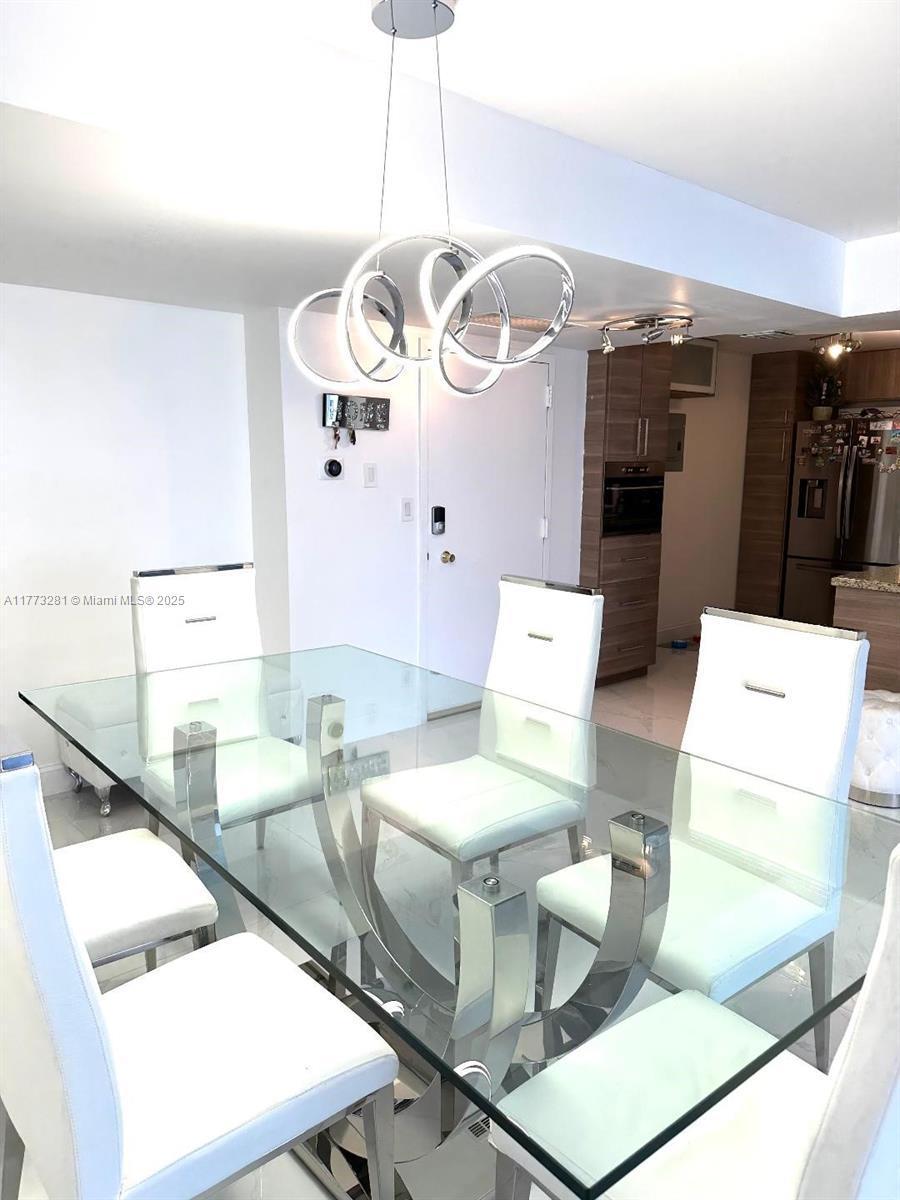 427 Golden Isles Drive, Unit 5G Hallandale Beach, FL 33009 - Photo 1 of 35 a bathroom with a sink mirror and vanity