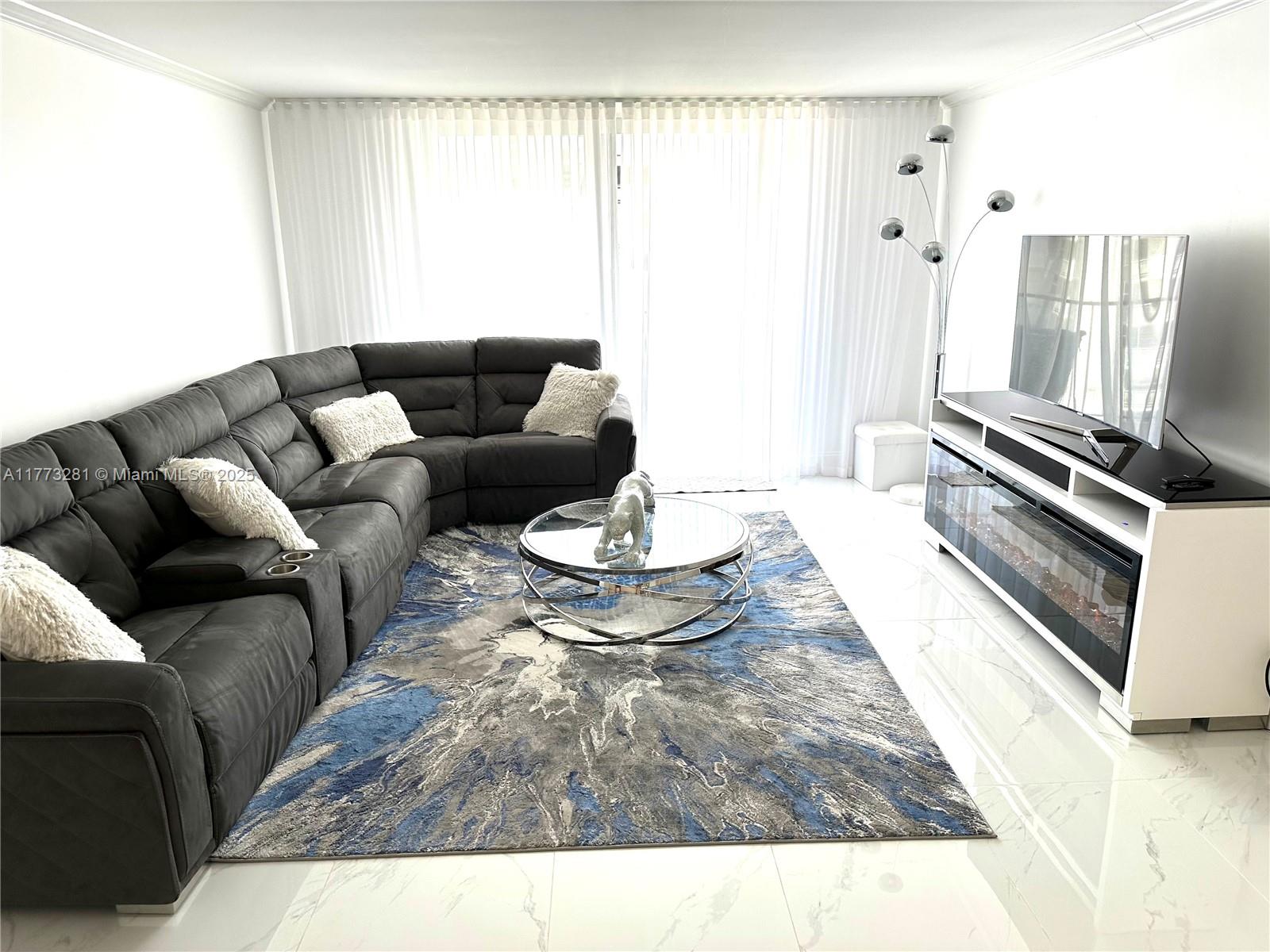 427 Golden Isles Drive, Unit 5G Hallandale Beach, FL 33009 - Photo 11 of 35 a living room with furniture and a couch