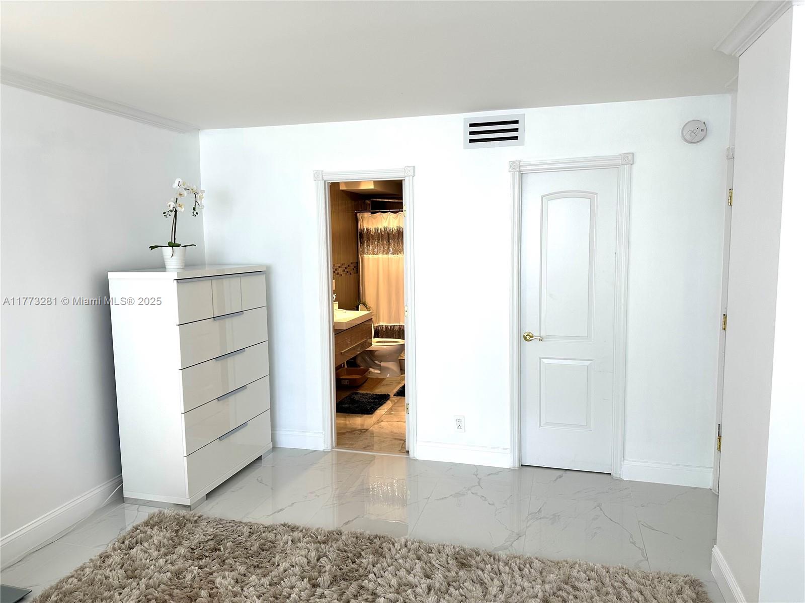 427 Golden Isles Drive, Unit 5G Hallandale Beach, FL 33009 - Photo 17 of 35 a view of a bedroom with closet and cabinet
