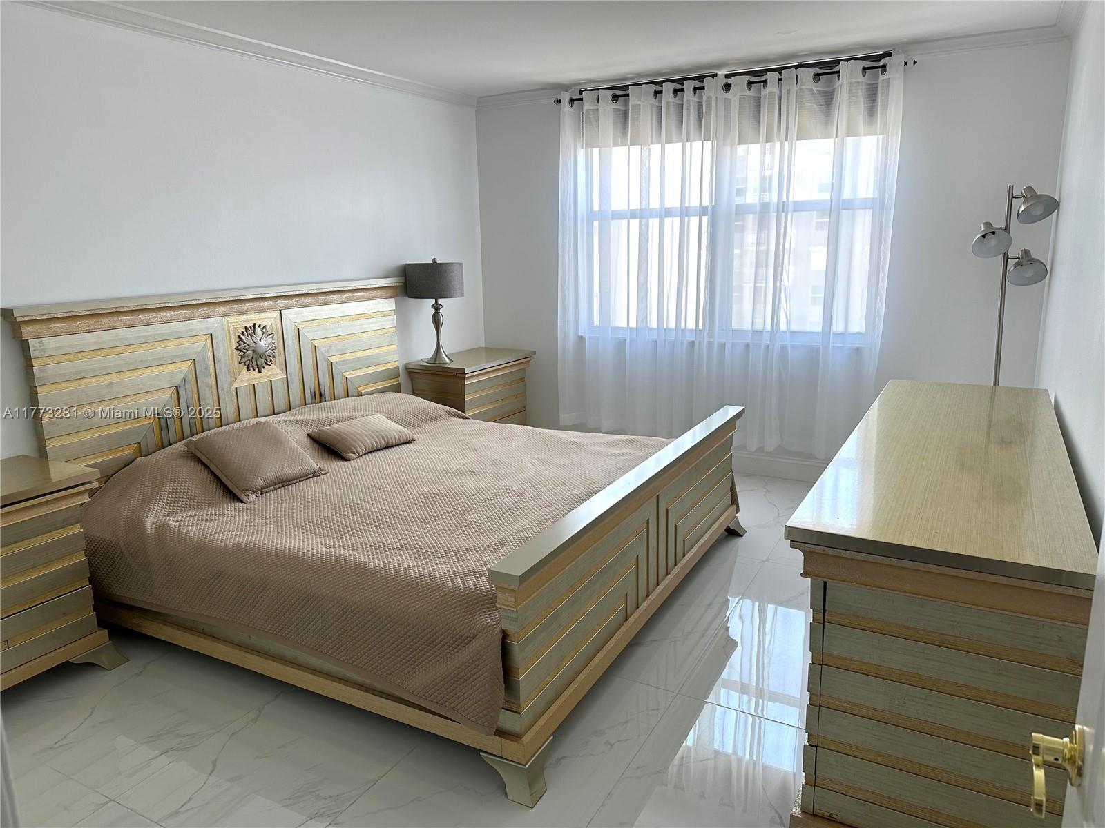 427 Golden Isles Drive, Unit 5G Hallandale Beach, FL 33009 - Photo 28 of 35 a bedroom with a bed and window