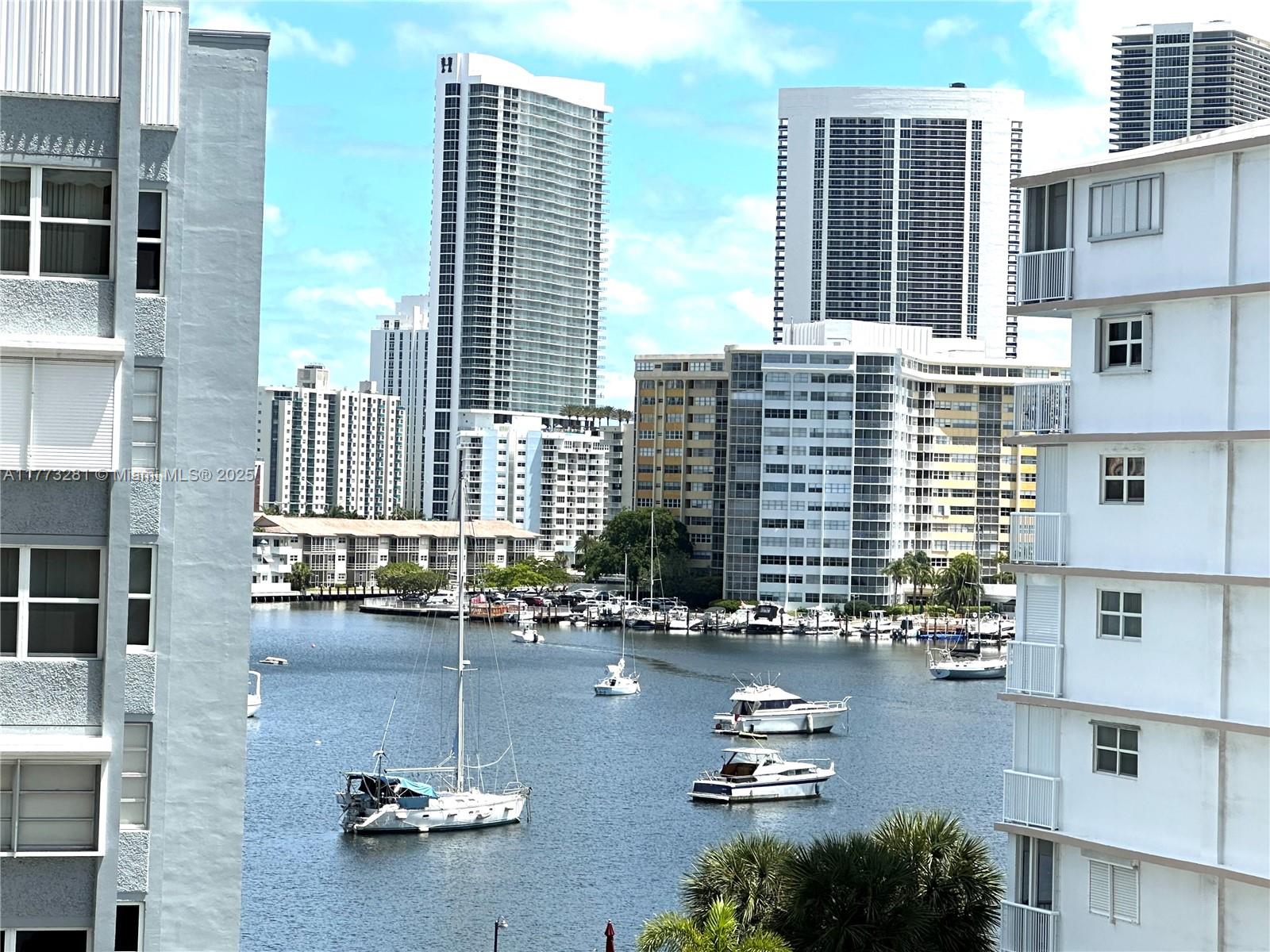 427 Golden Isles Drive, Unit 5G Hallandale Beach, FL 33009 - Photo 34 of 35 a swimming pool view with a outdoor seating