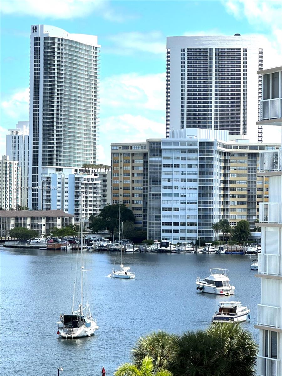 427 Golden Isles Drive, Unit 5G Hallandale Beach, FL 33009 - Photo 35 of 35 a front view of a building with glass windows
