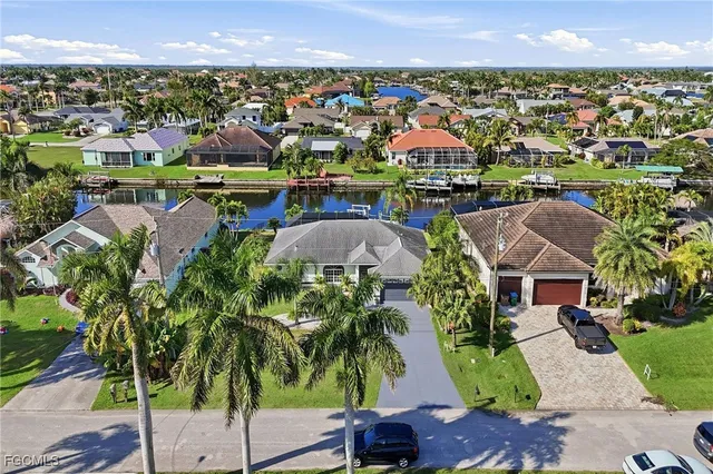 an aerial view of residential houses with outdoor space and swimming pool
