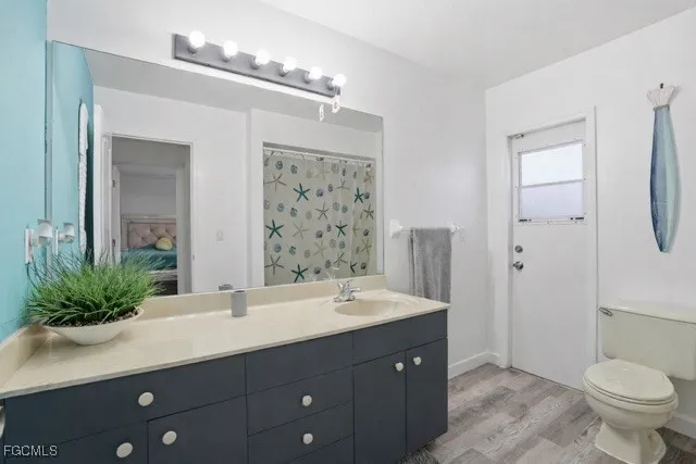 a white toilet sitting next to a shower curtain