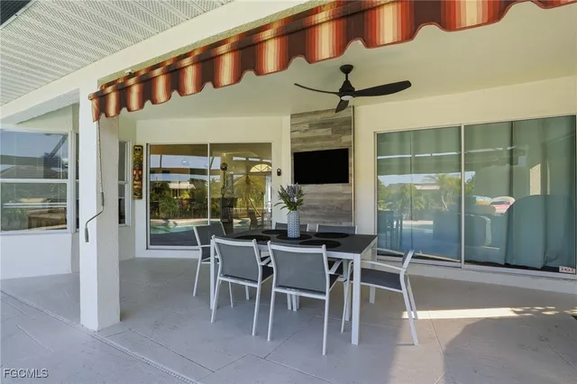 a dining room with furniture a floor to ceiling window and outdoor view