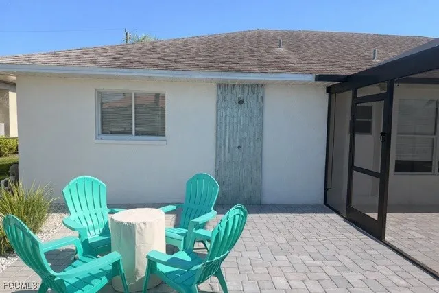 a view of a chair and table in backyard