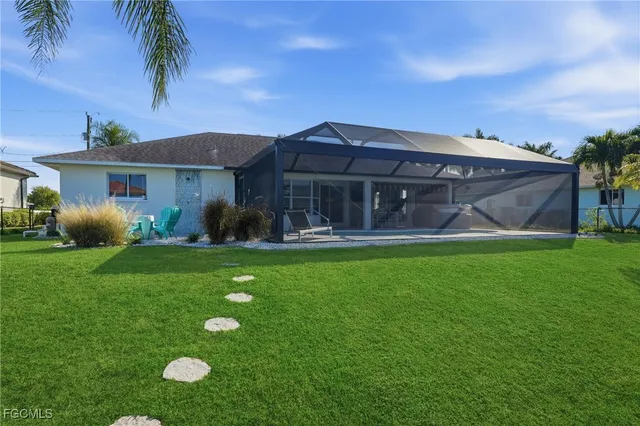 a view of a house with a garden and a patio