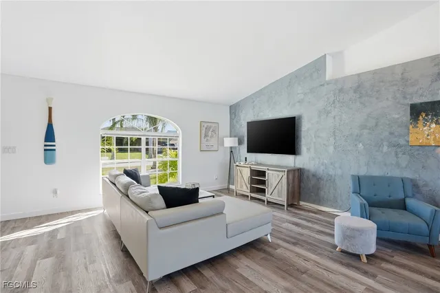 a living room with furniture and kitchen view