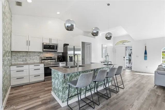 a view of kitchen with breakfast area and windows