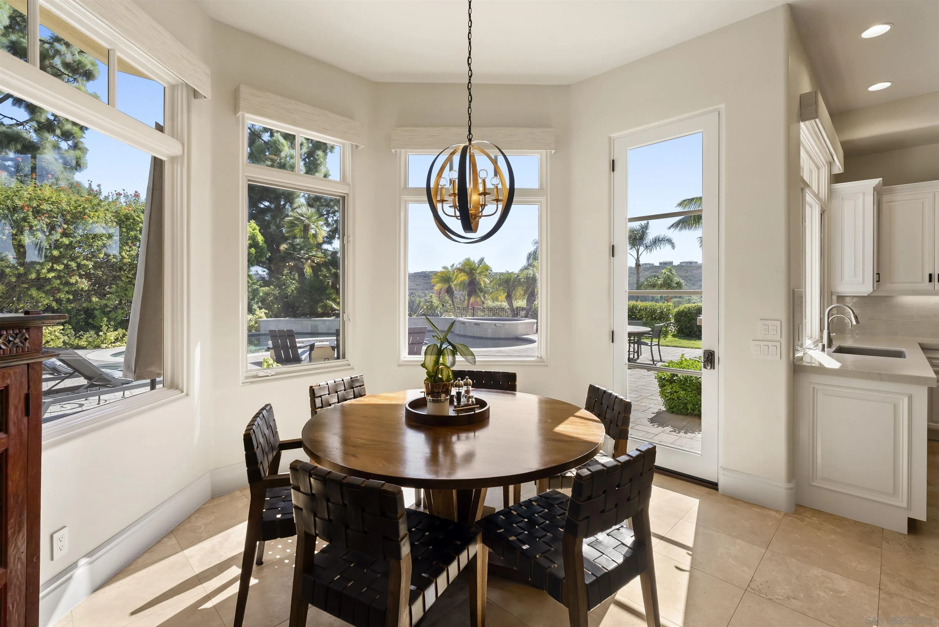 14480 Bellvista Drive Rancho Santa Fe, CA 92067 - Photo 11 of 28 a dining room with furniture a chandelier and a rug