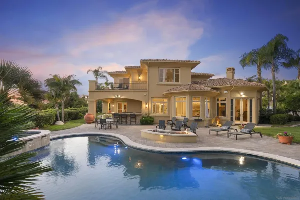 a view of a swimming pool with outdoor seating