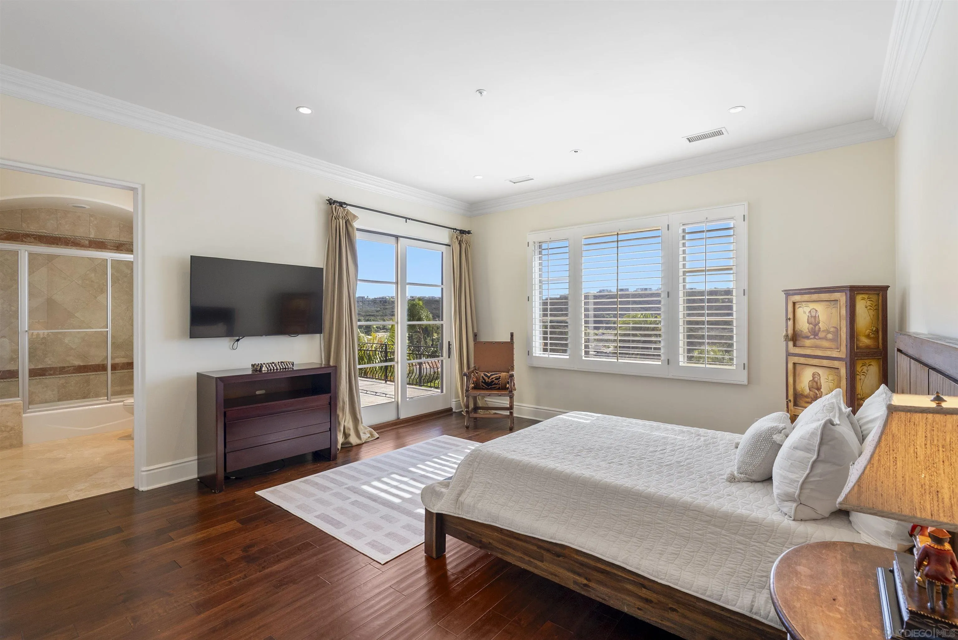 14480 Bellvista Drive Rancho Santa Fe, CA 92067 - Photo 21 of 28 a bedroom with a bed and flat screen tv