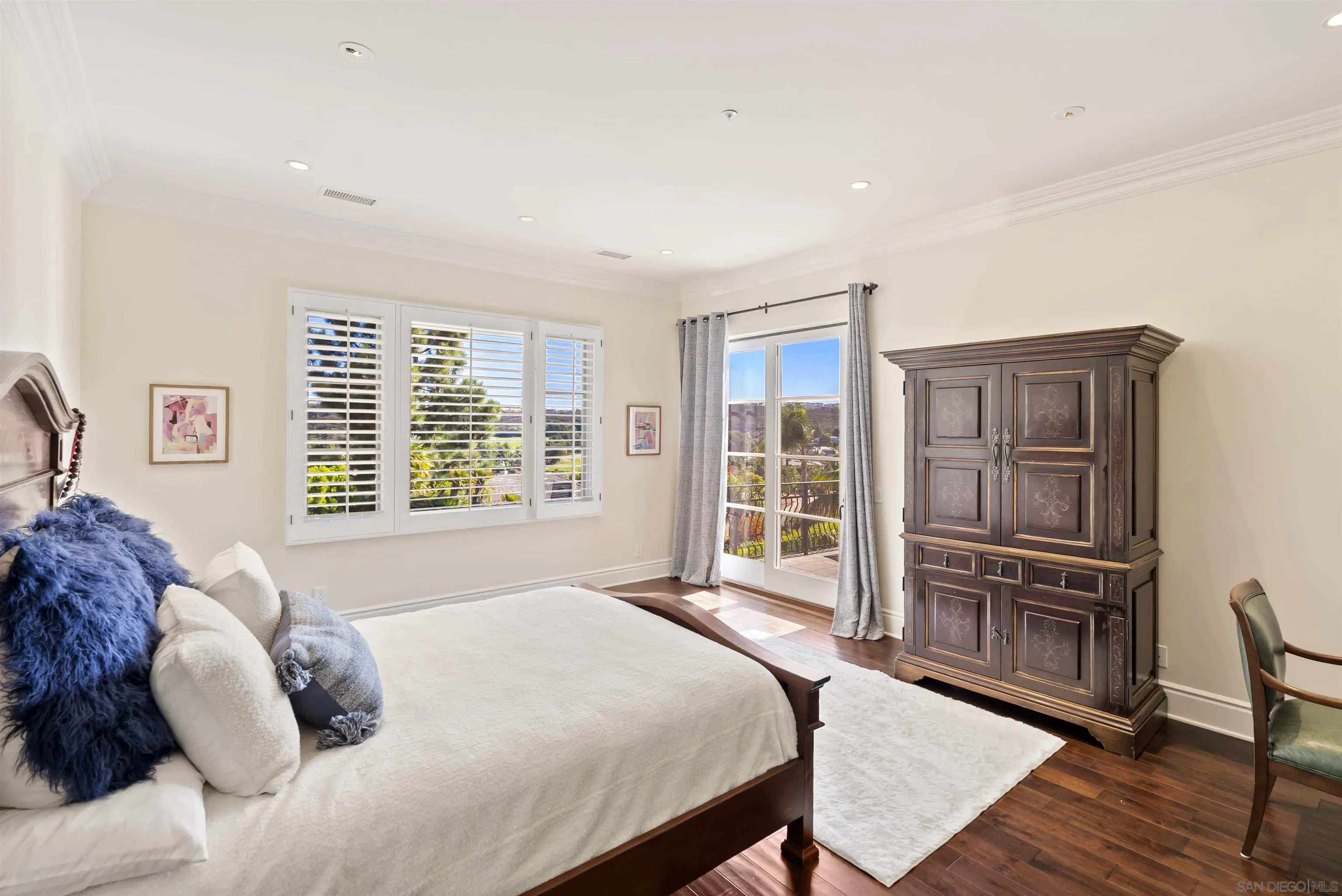 14480 Bellvista Drive Rancho Santa Fe, CA 92067 - Photo 22 of 28 a bedroom with a bed cabinets and wooden floor