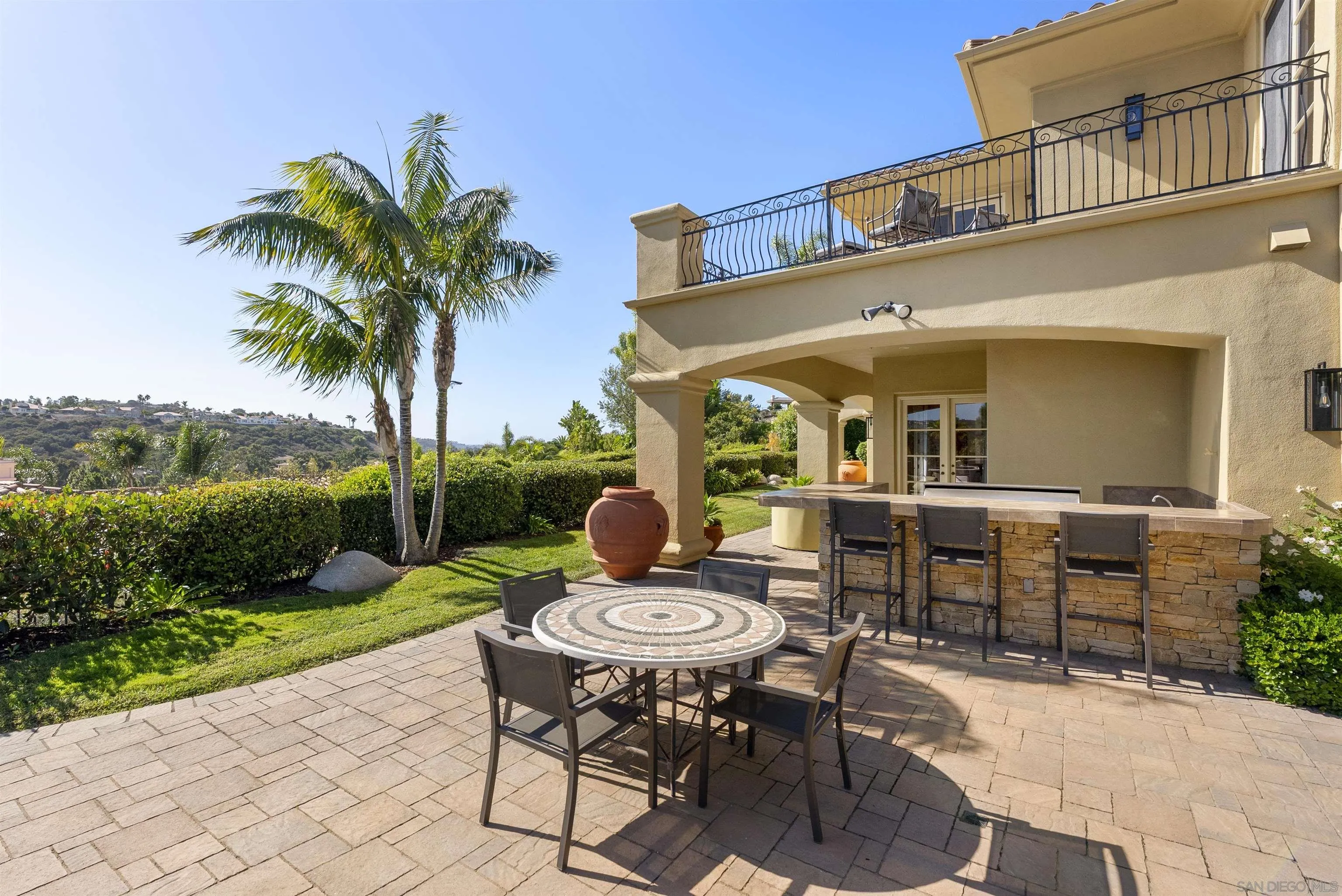 14480 Bellvista Drive Rancho Santa Fe, CA 92067 - Photo 24 of 28 a view of a patio with table and chairs potted plants and palm tree