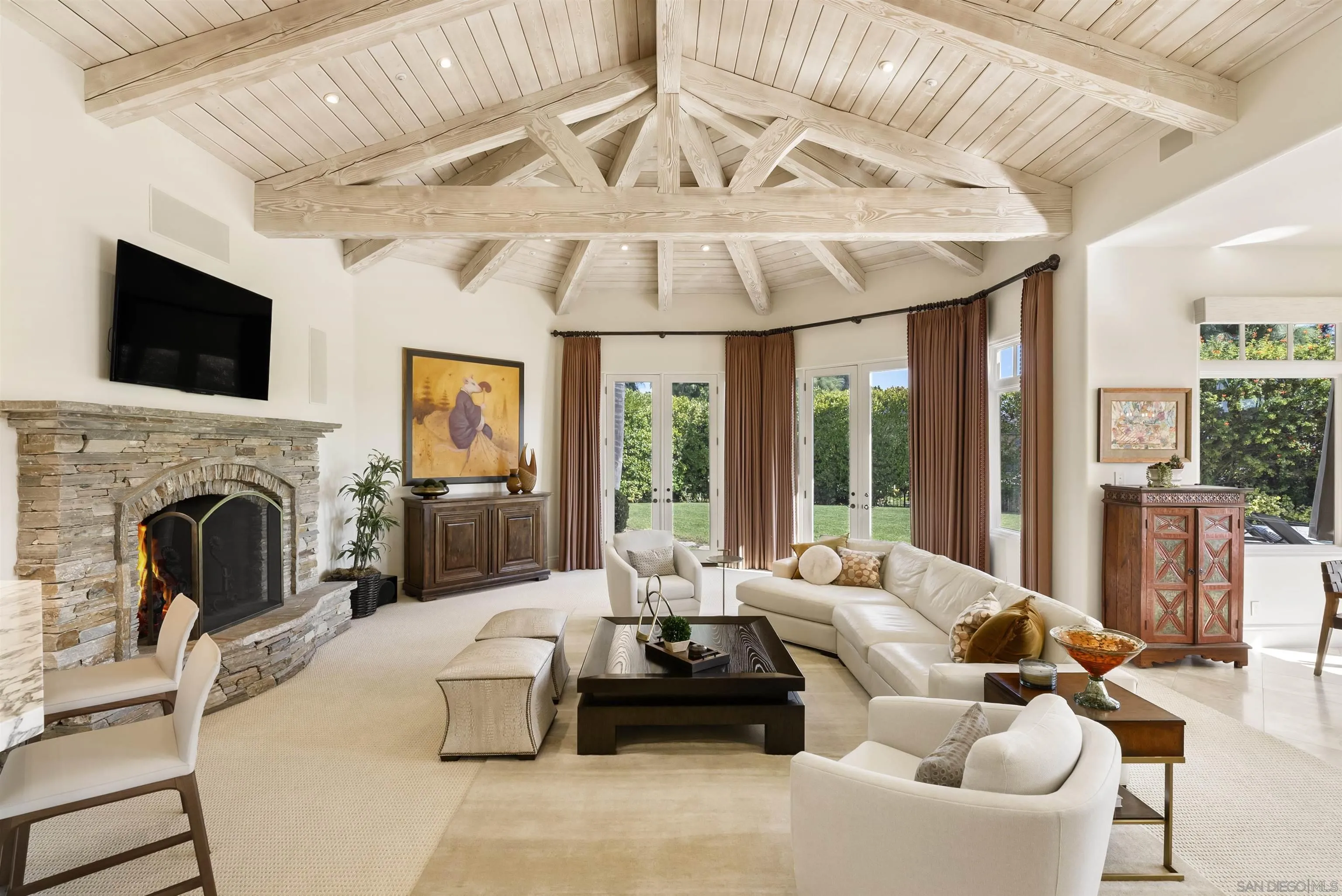 14480 Bellvista Drive Rancho Santa Fe, CA 92067 - Photo 4 of 28 a living room with furniture a fireplace and a flat screen tv