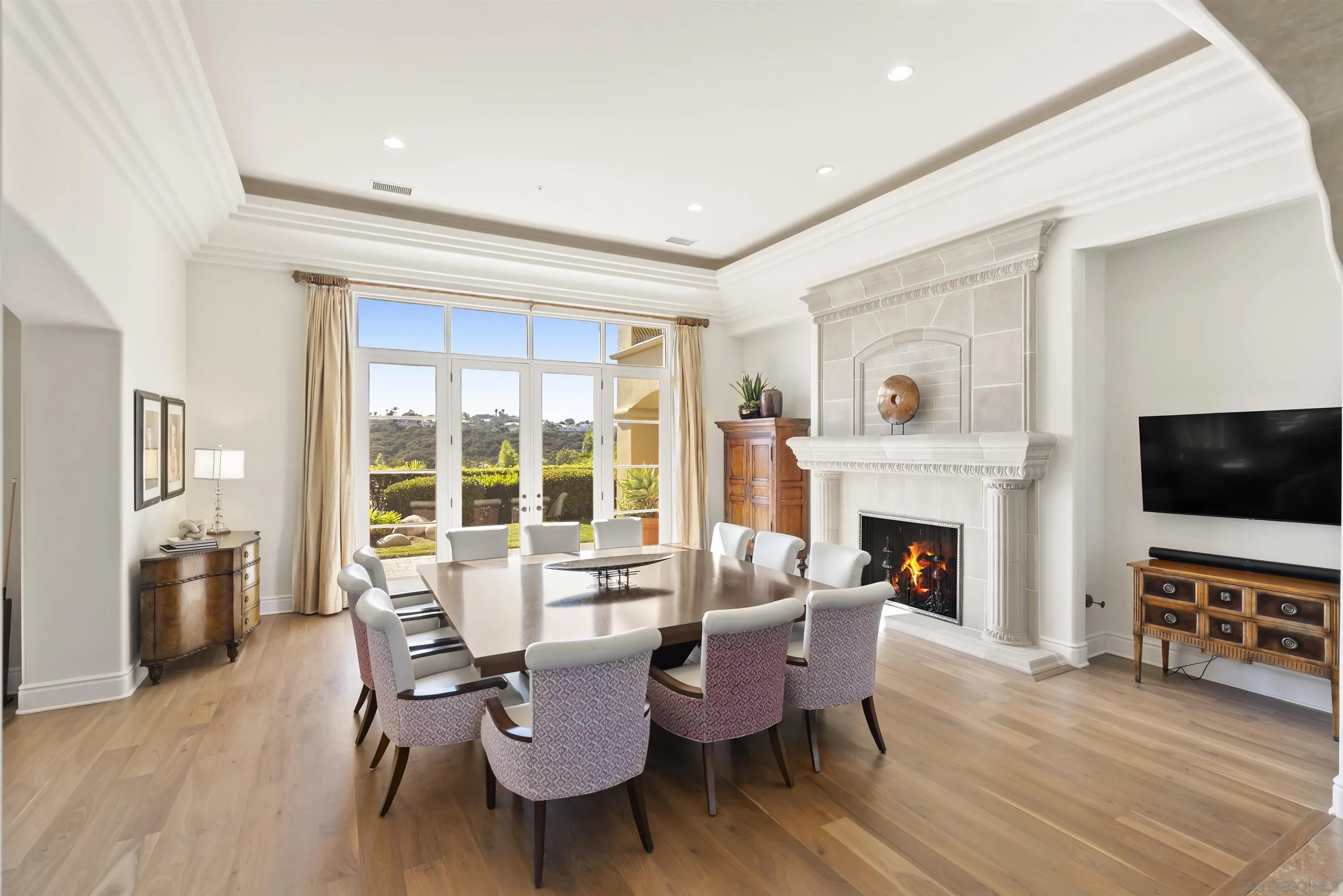 14480 Bellvista Drive Rancho Santa Fe, CA 92067 - Photo 8 of 28 a dining room with furniture a fireplace and wooden floor
