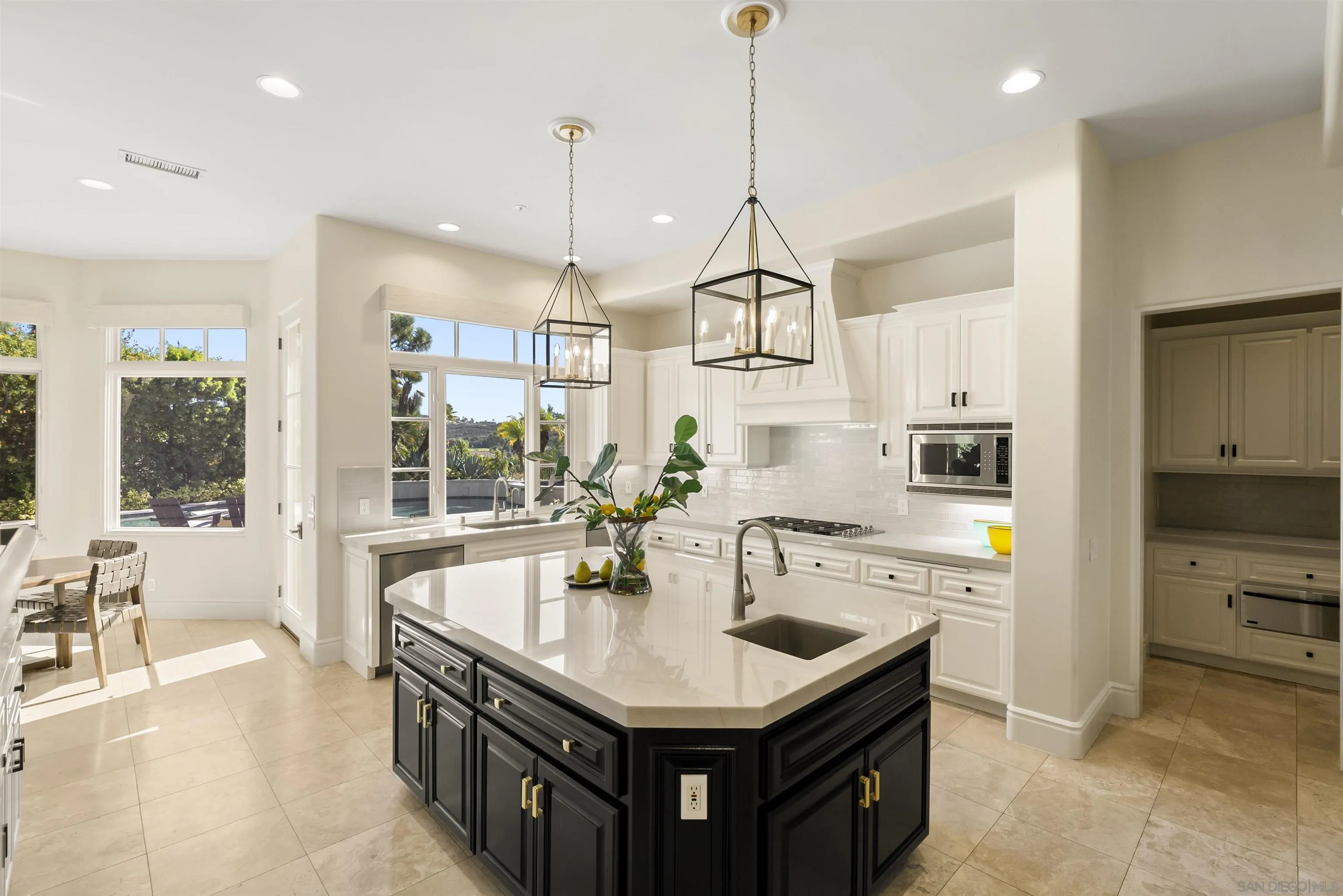 14480 Bellvista Drive Rancho Santa Fe, CA 92067 - Photo 9 of 28 a kitchen with stainless steel appliances granite countertop a sink a counter space and a floor to ceiling window