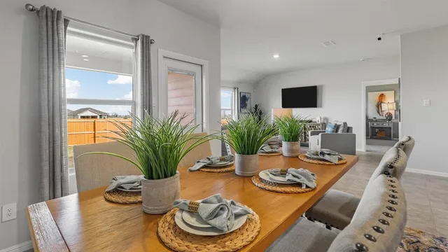 a view of a dining room with furniture and window