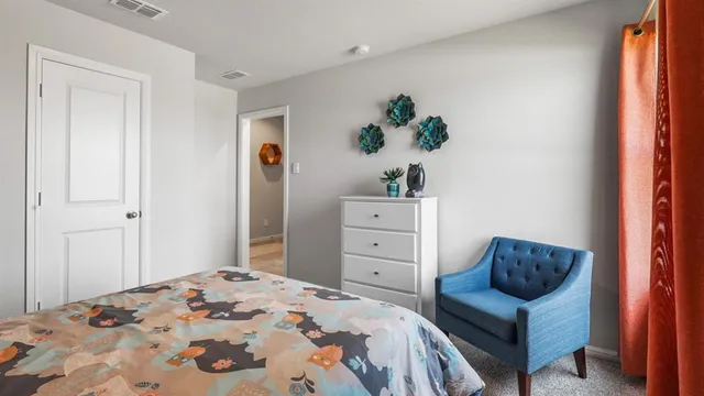 a bedroom with a bed and a painting on the wall