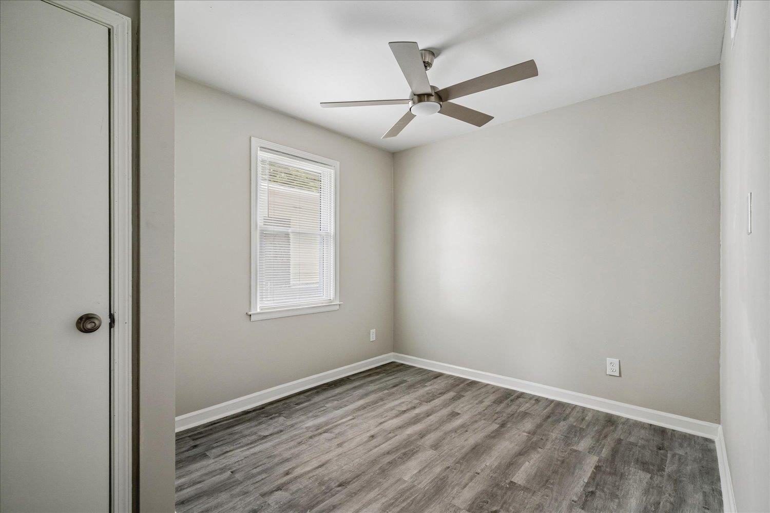 2518 Manchester Road Memphis, TN 38114 - Photo 16 of 23 Room featuring wood-finish flooring, a contemporary ceiling fan with integrated lighting, and a window with blinds