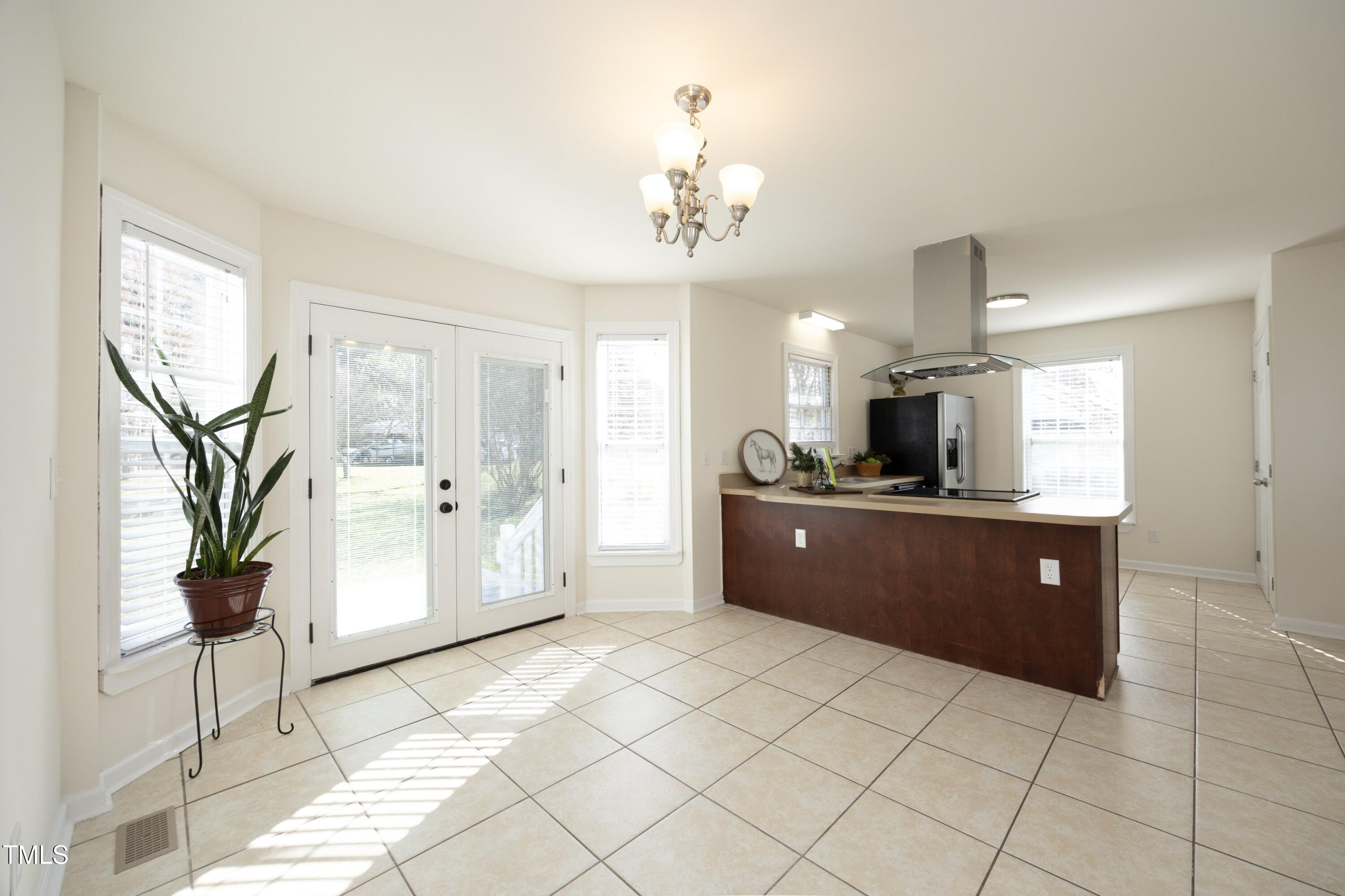 101 Ryans Run Youngsville, NC 27596 - Photo 12 of 33 a large kitchen with stainless steel appliances kitchen island granite countertop a refrigerator and a sink