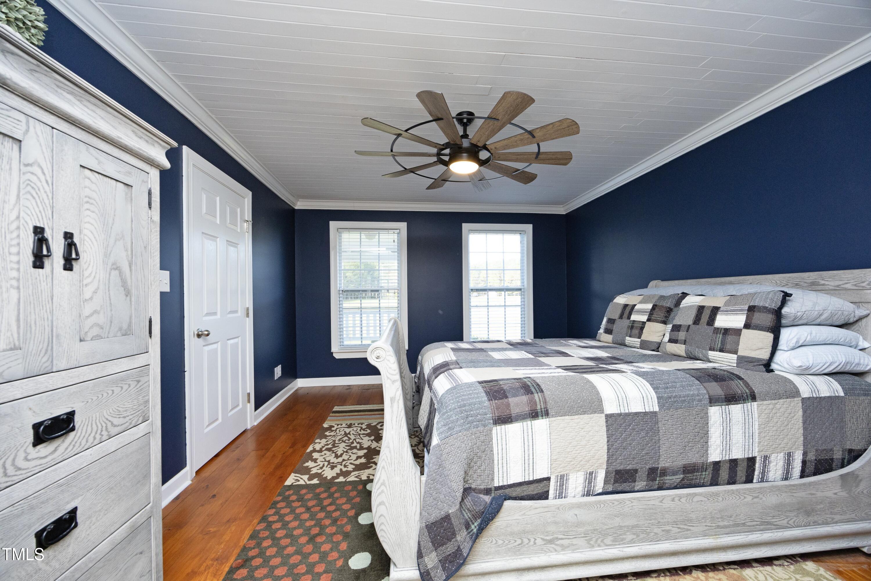 101 Ryans Run Youngsville, NC 27596 - Photo 16 of 33 a bedroom with a large bed and a chandelier