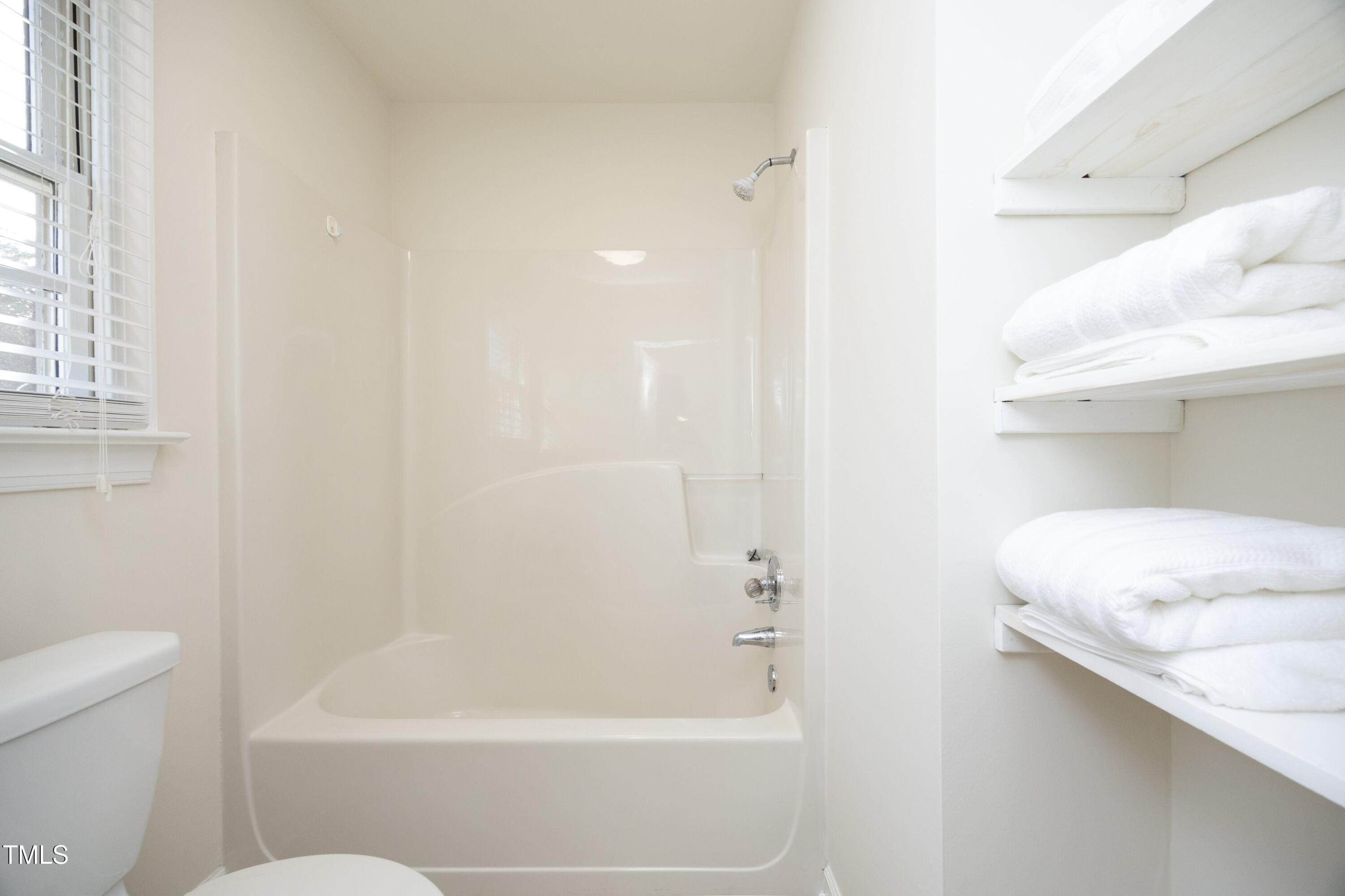 101 Ryans Run Youngsville, NC 27596 - Photo 18 of 33 a bathroom with a bathtub and a toilet