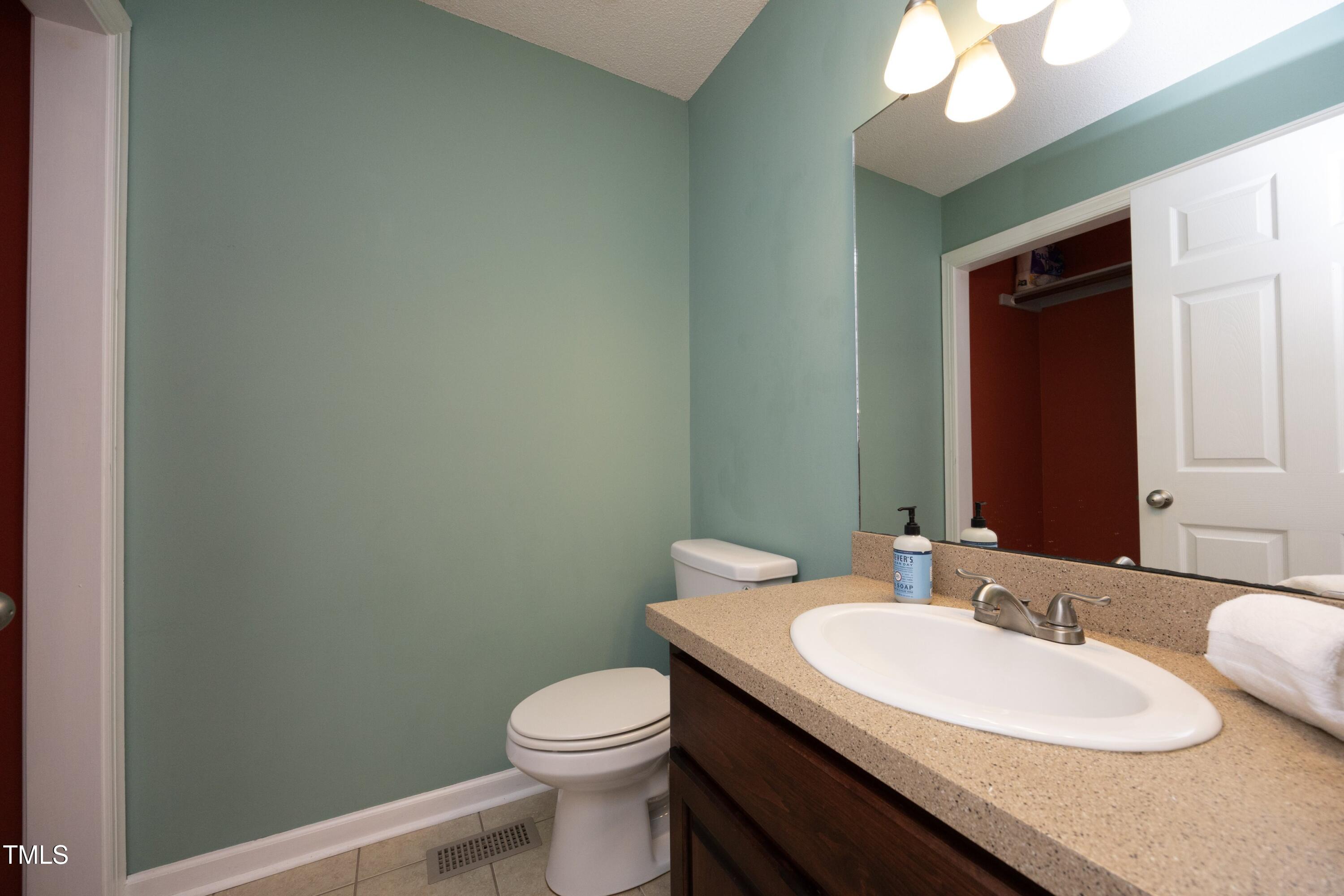 101 Ryans Run Youngsville, NC 27596 - Photo 20 of 33 a bathroom with a granite countertop sink and a mirror