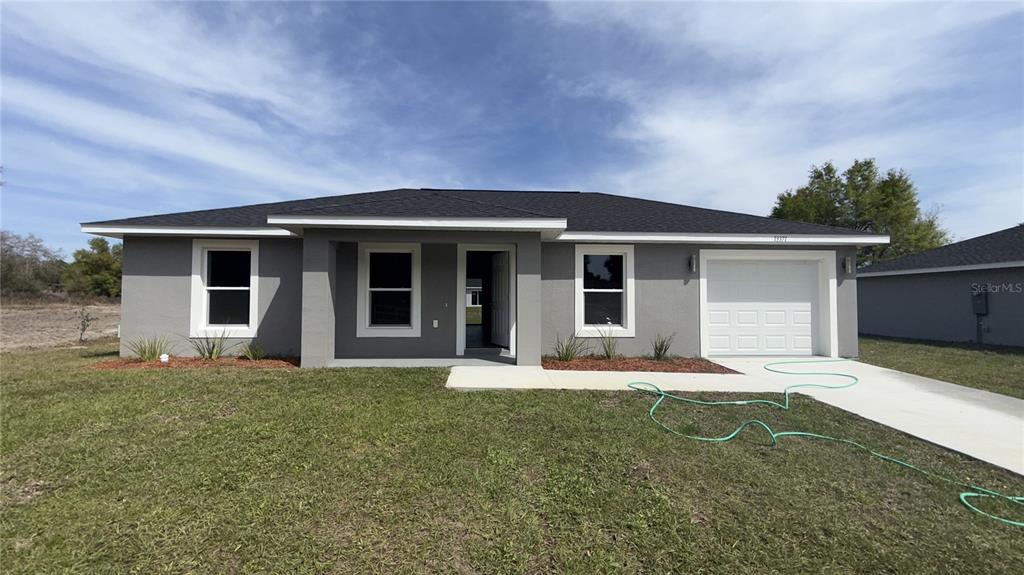 13371 Southwest 112th Place Dunnellon, FL 34432 - Photo 1 of 1 front view of a house with a yard